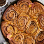 overhead image of caramel macchiato cinnamon roll cake in a skillet