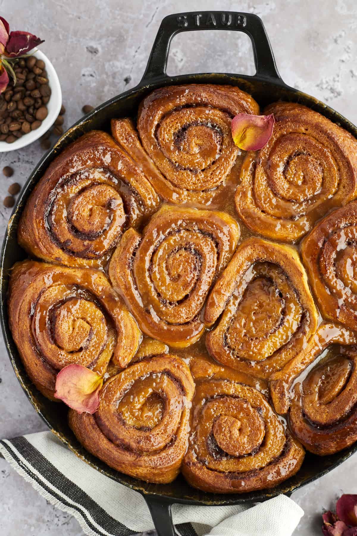 overhead image of a skillet of baked caramel macchiato cinnamon roll cake