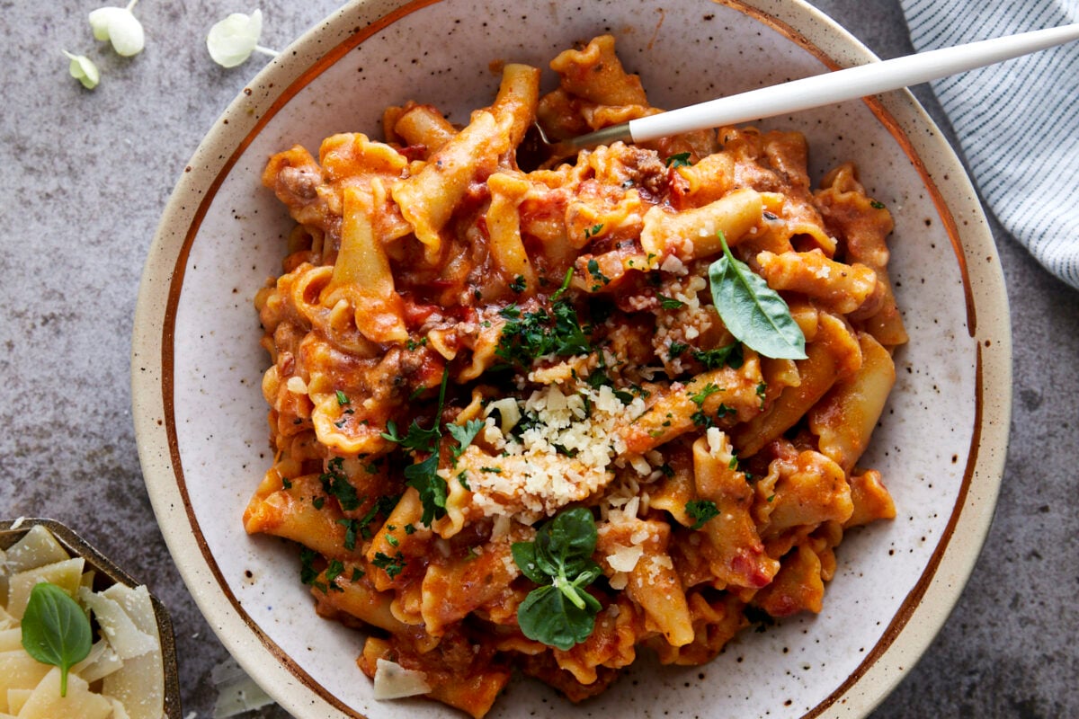 A bowl of one pot lasagna pasta topped with Parmesan cheese.