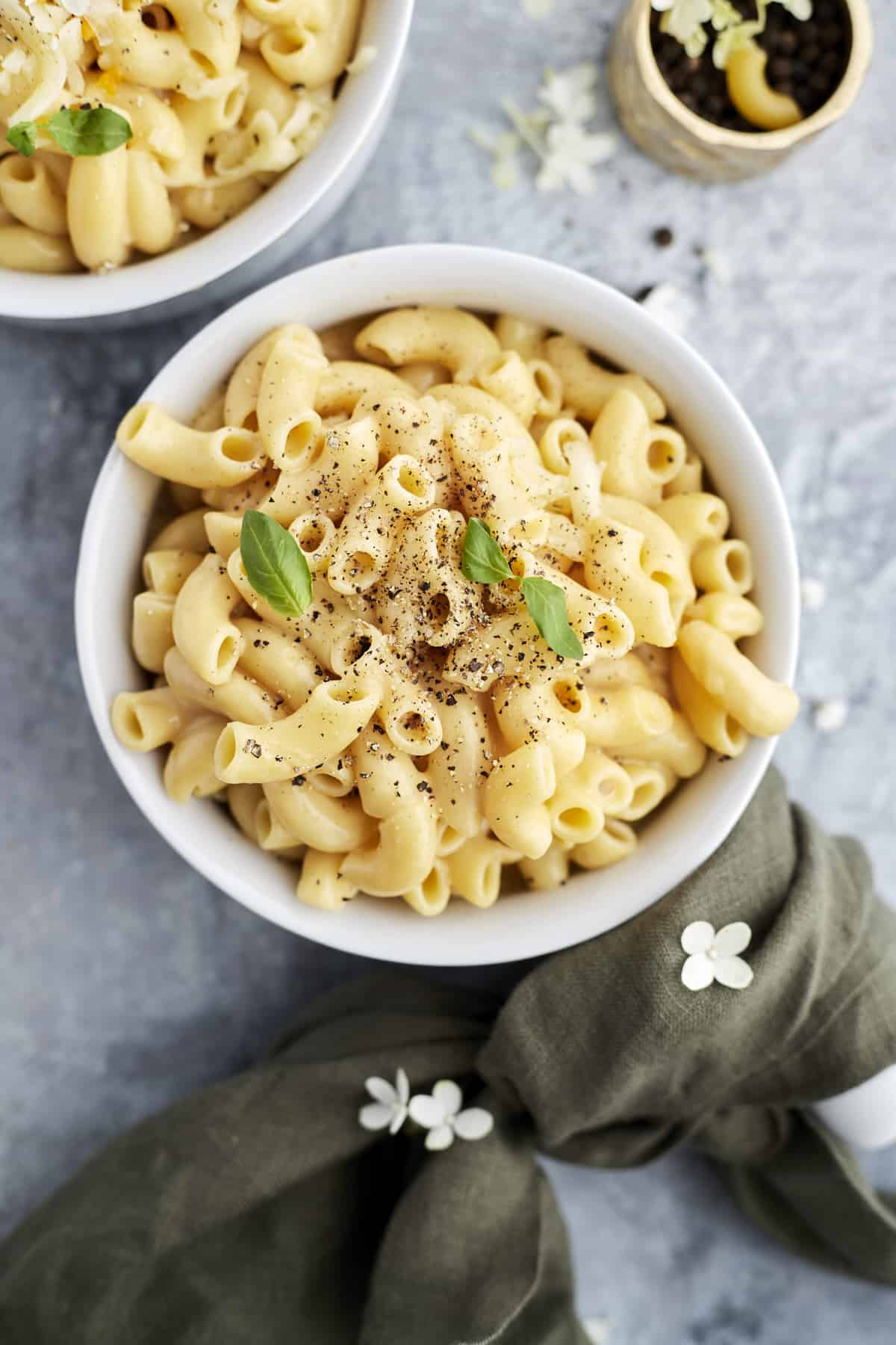 overhead image of a bowl of one pot mac and cheese topped with fresh pepper