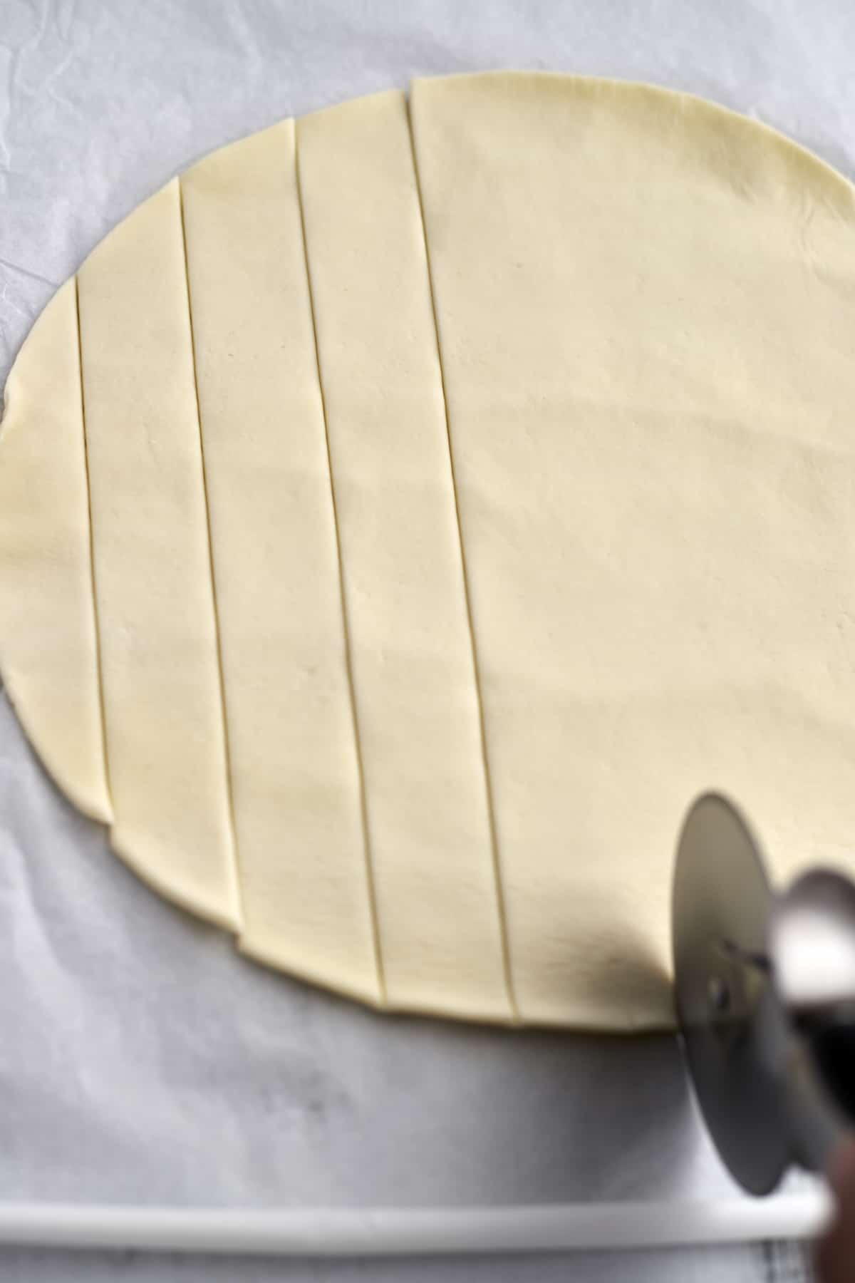 cobbler dough being sliced into strips