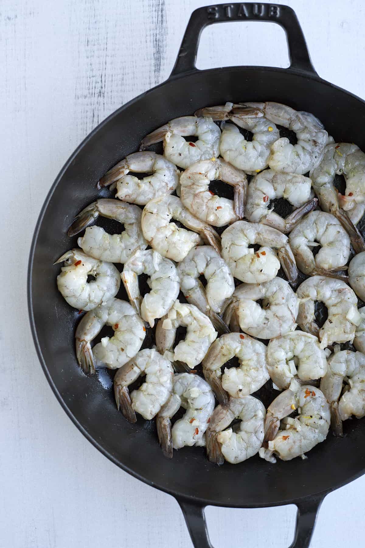 raw shrimp in a skillet to make baked shrimp scampi