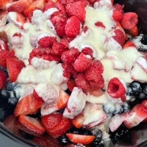 overhead image of summer berry cobbler in a slow cooker