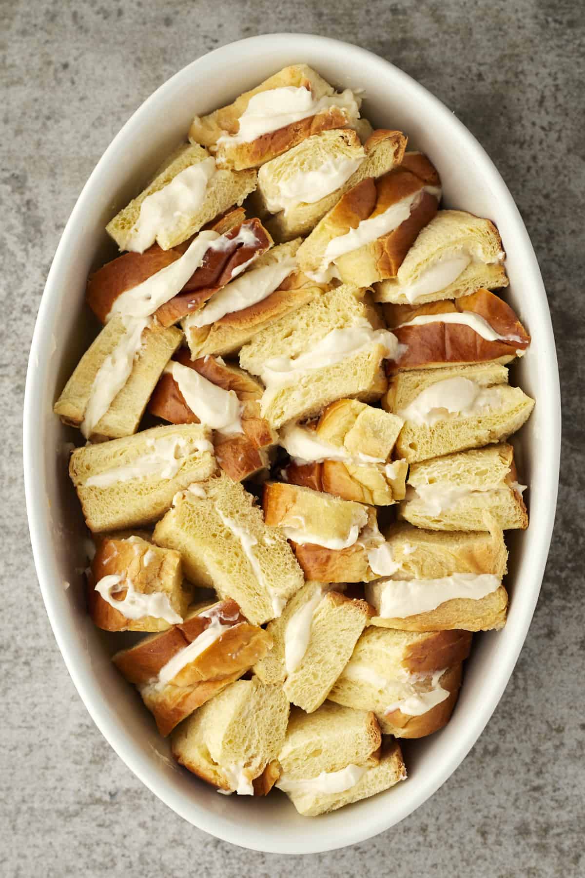 cannoli stuffed french toast pieces in an oval dish