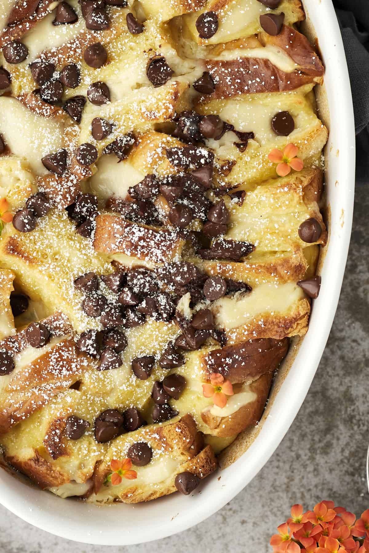 close up image of cannoli baked french toast topped with chocolate chips