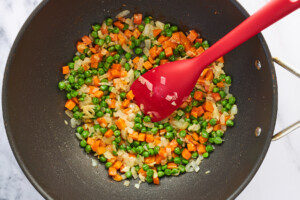 Veggies being stirred in a wok.