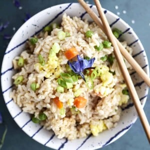 a bowl of easy fried rice with eggs with chopsticks on top