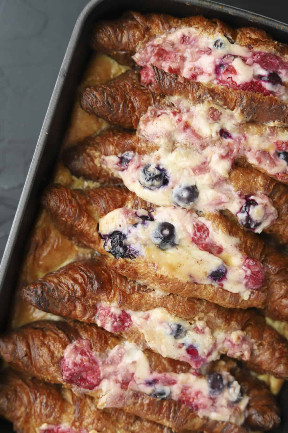overhead of baked berry stuffed croissant french toast