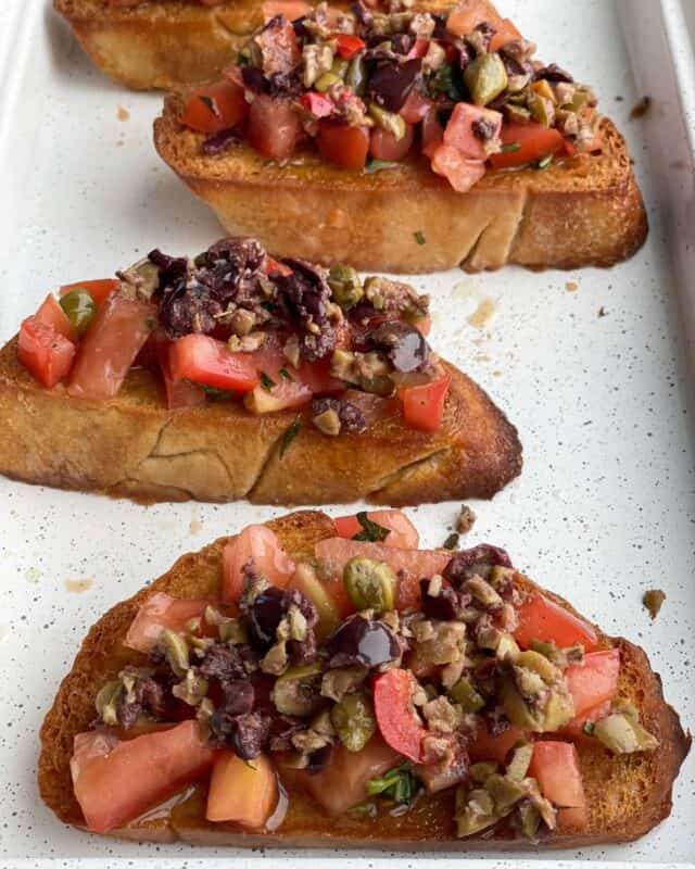 four pieces of olive tapenade bruschetta