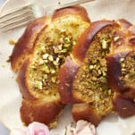 Close up image of a serving of Baklava French toast on a plate with a fork on the side.