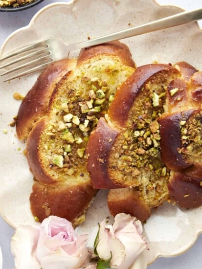 Close up image of a serving of Baklava French toast on a plate with a fork on the side.