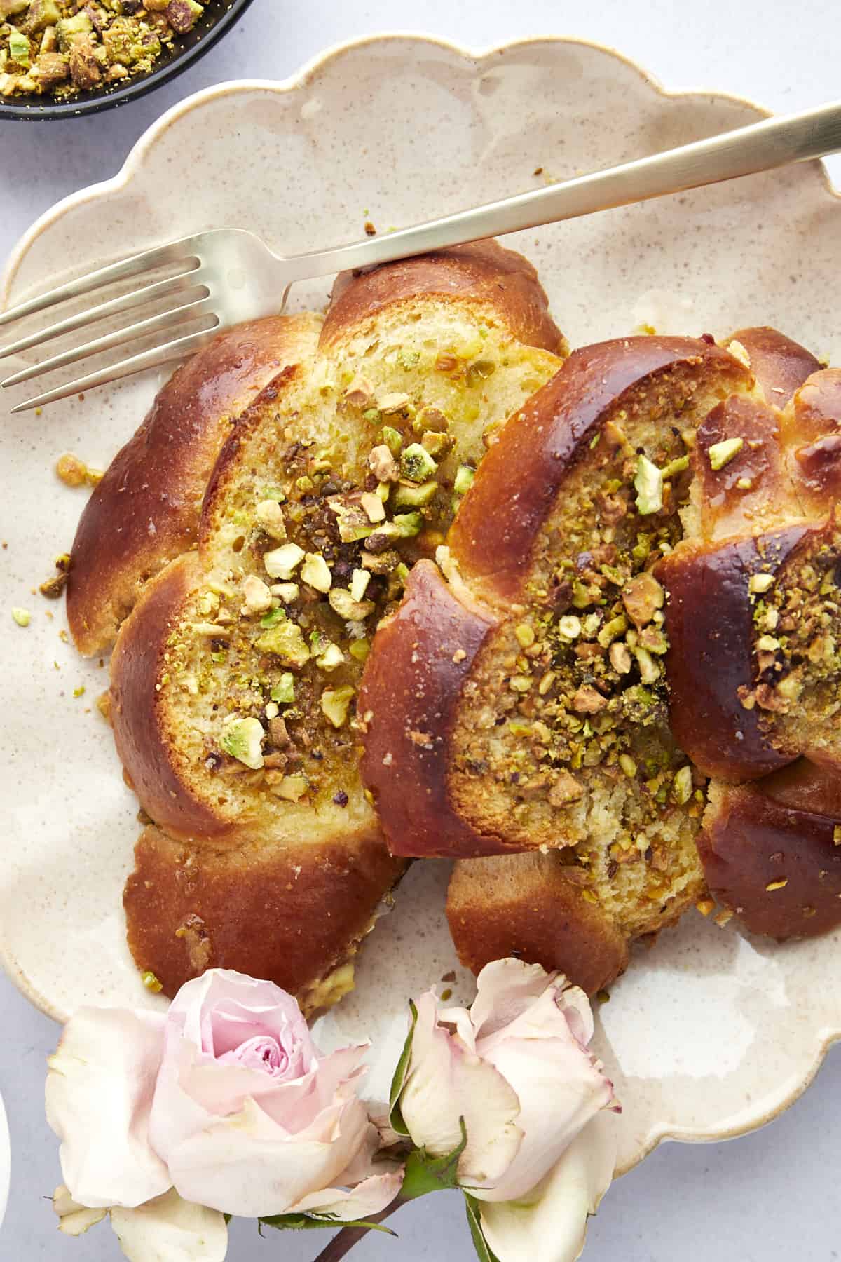 Slices of baklava french toast on a plate with a fork. 