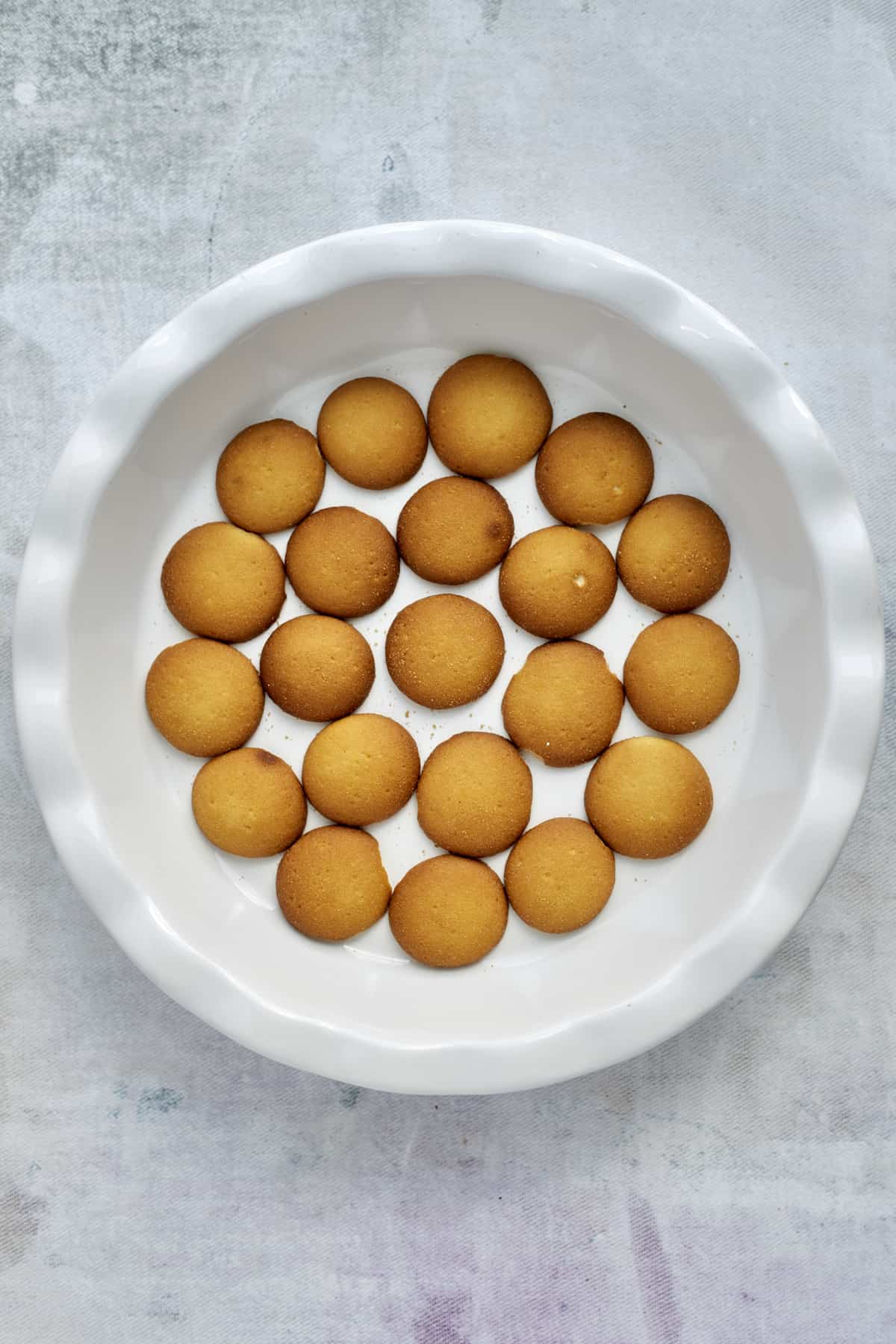 Nilla wafers in the bottom of a baking dish.