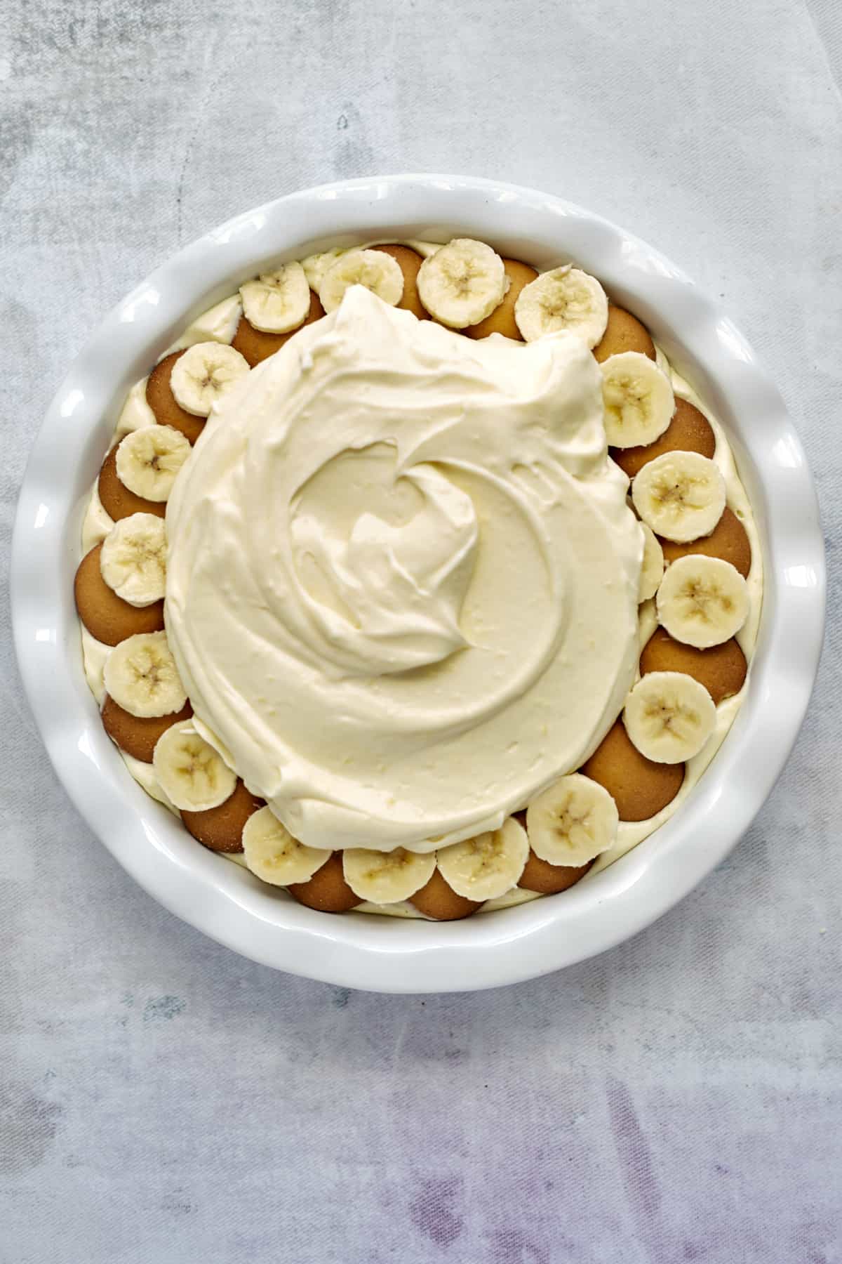 second layer of vanilla pudding over Nilla wafers and banana coins in a baking dish