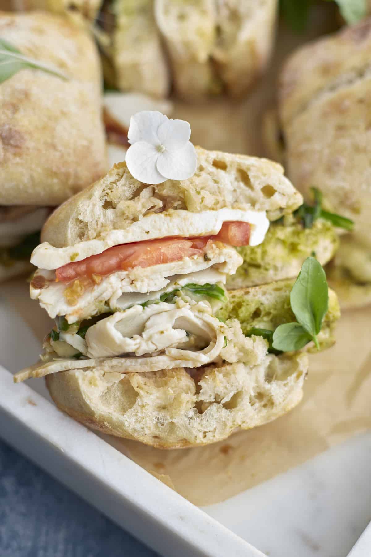 a baked turkey caprese sandwich with a bite taken out.