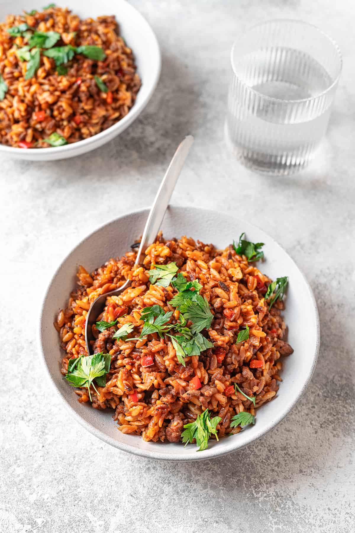 egyptian orzo pasta on a plate with parsley and serving spoon