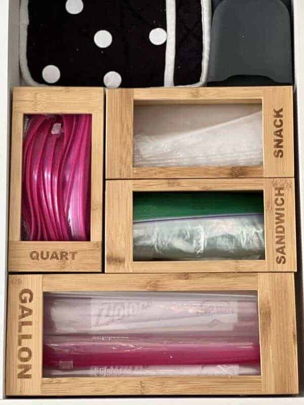 a picture of the insider of a kitchen drawer with a gallon, quart, sandwich, and snack sized Ziploc bag organizers inside