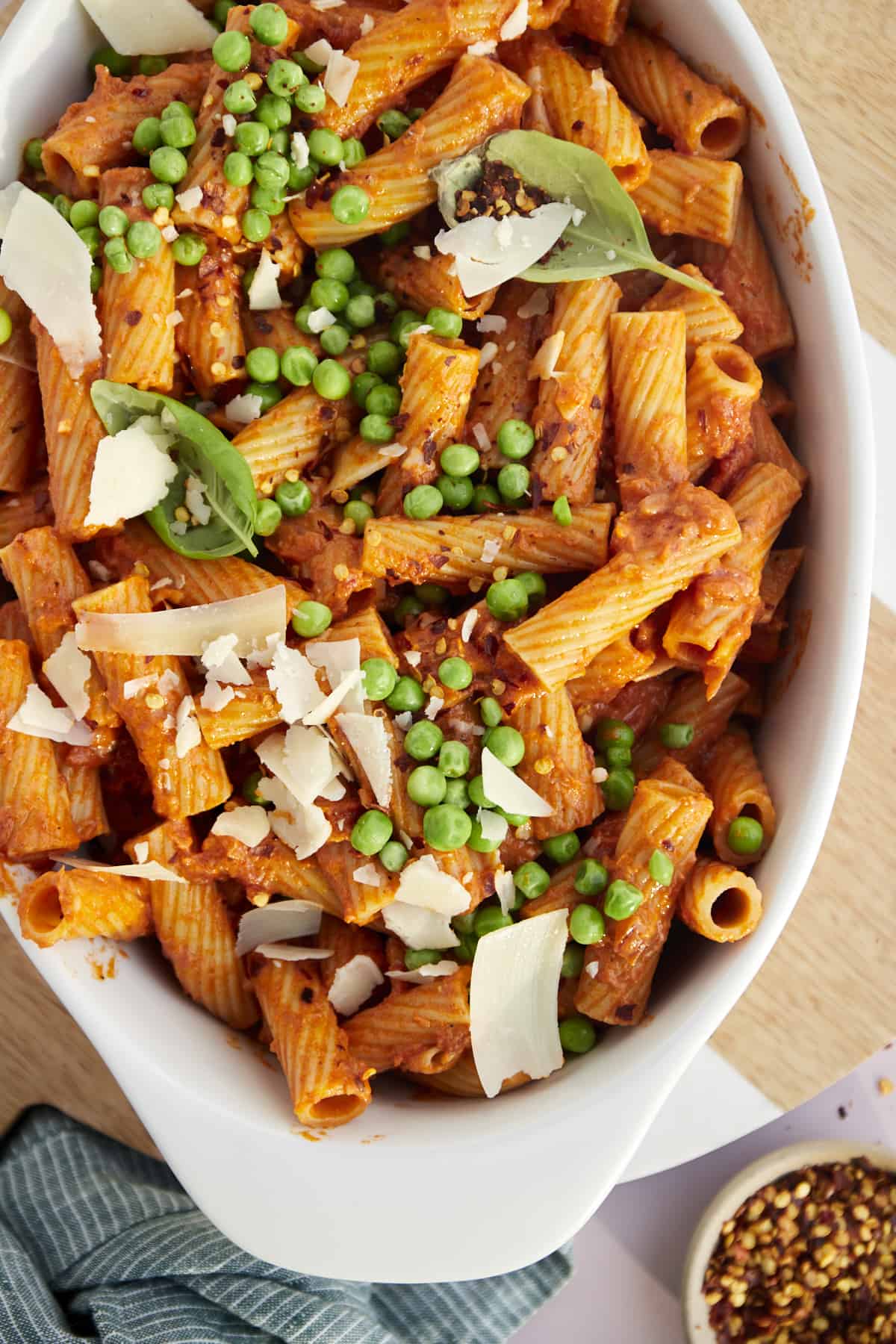 baked spicy rigatoni with peas and shredded parmesan