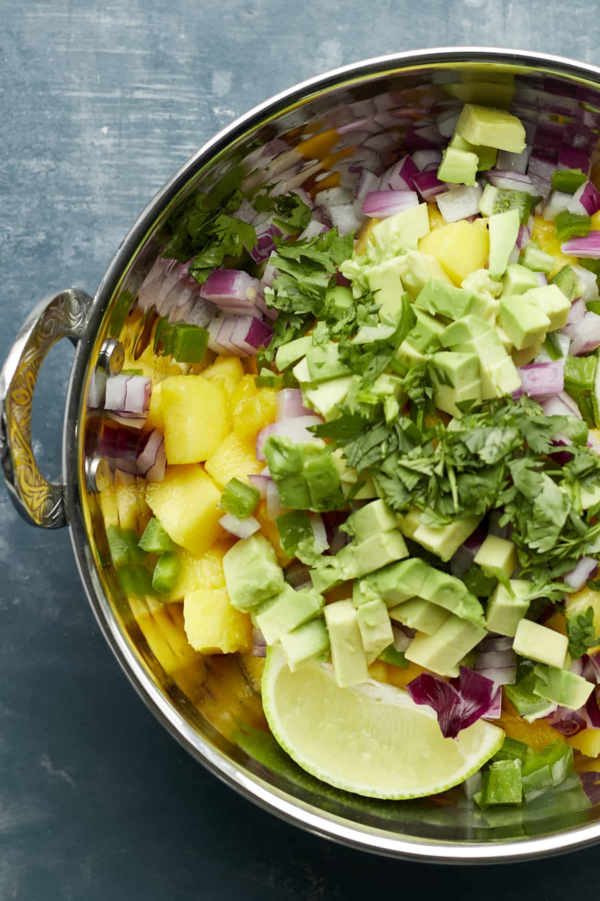 overhead image of ingredients for mango salsa in a bowl 