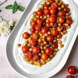 overhead image of Creamy Whipped Feta Dip with Roasted Tomatoes and Chickpeas in a white platter