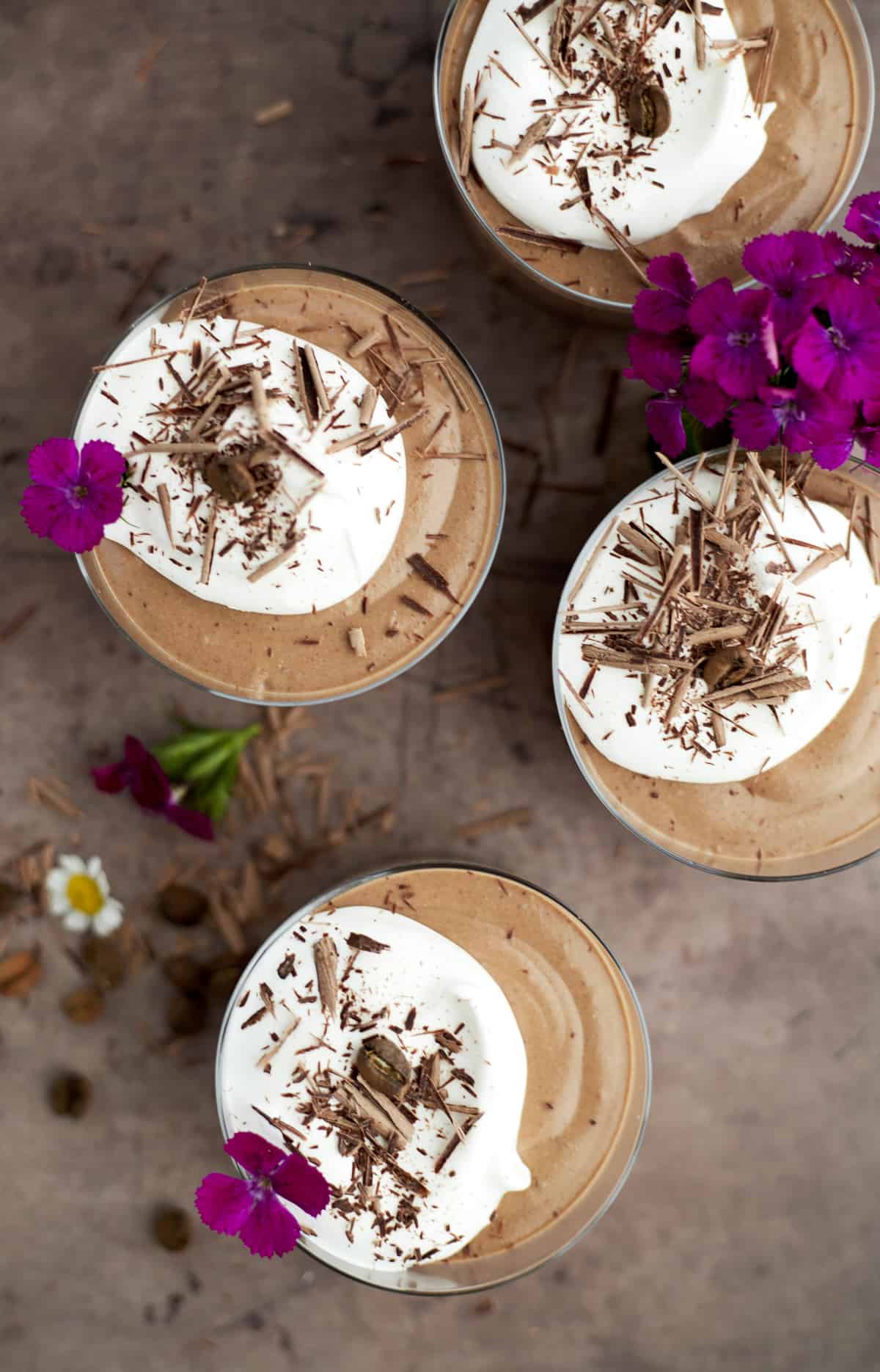 four chocolate mousse cups in small serving dishes