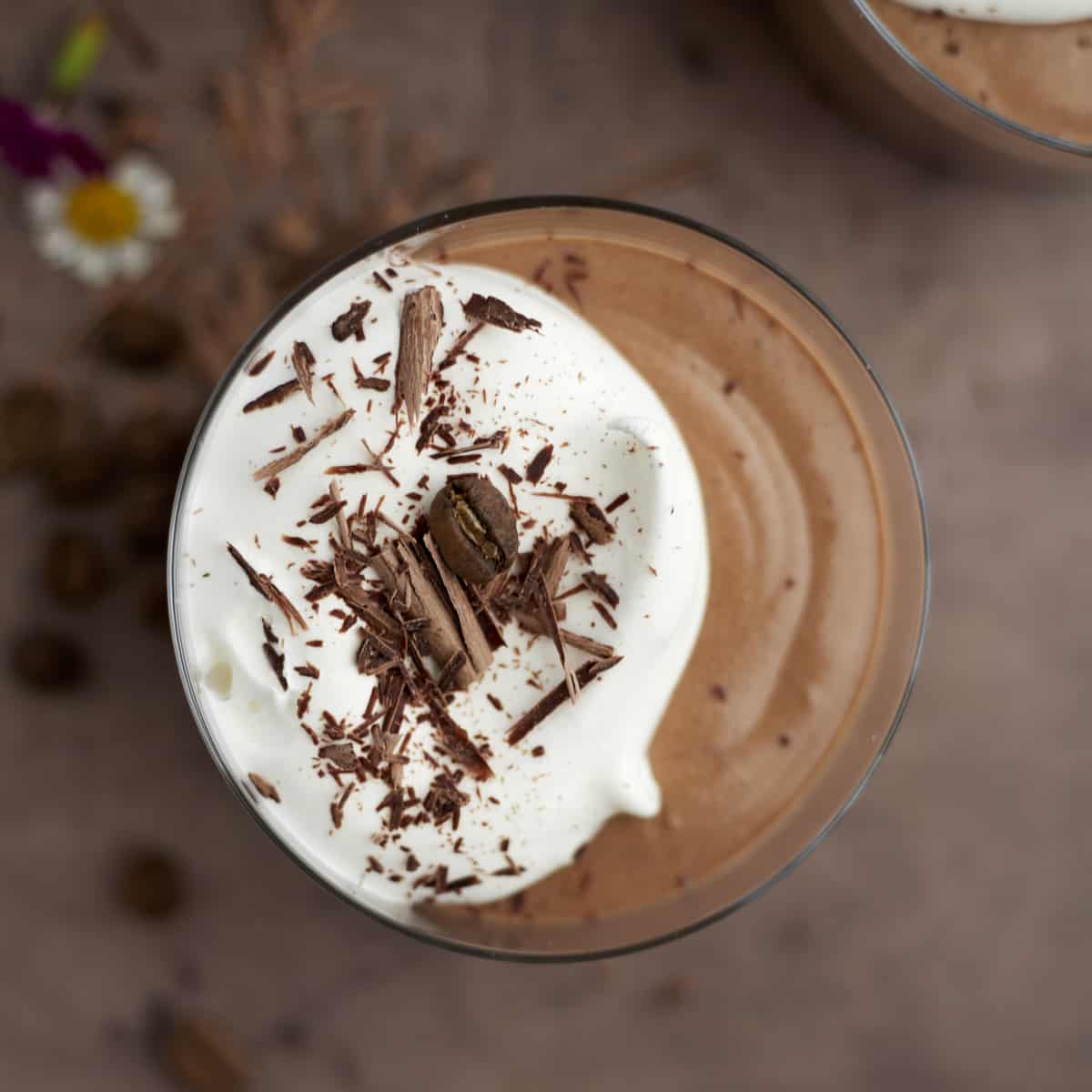 overhead single serving chocolate mousse with whipped cream and chocolate shavings