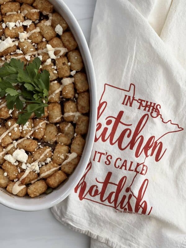 a kofta hot dish next to a towel that reads "In this kitchen it's called hotdish" 
