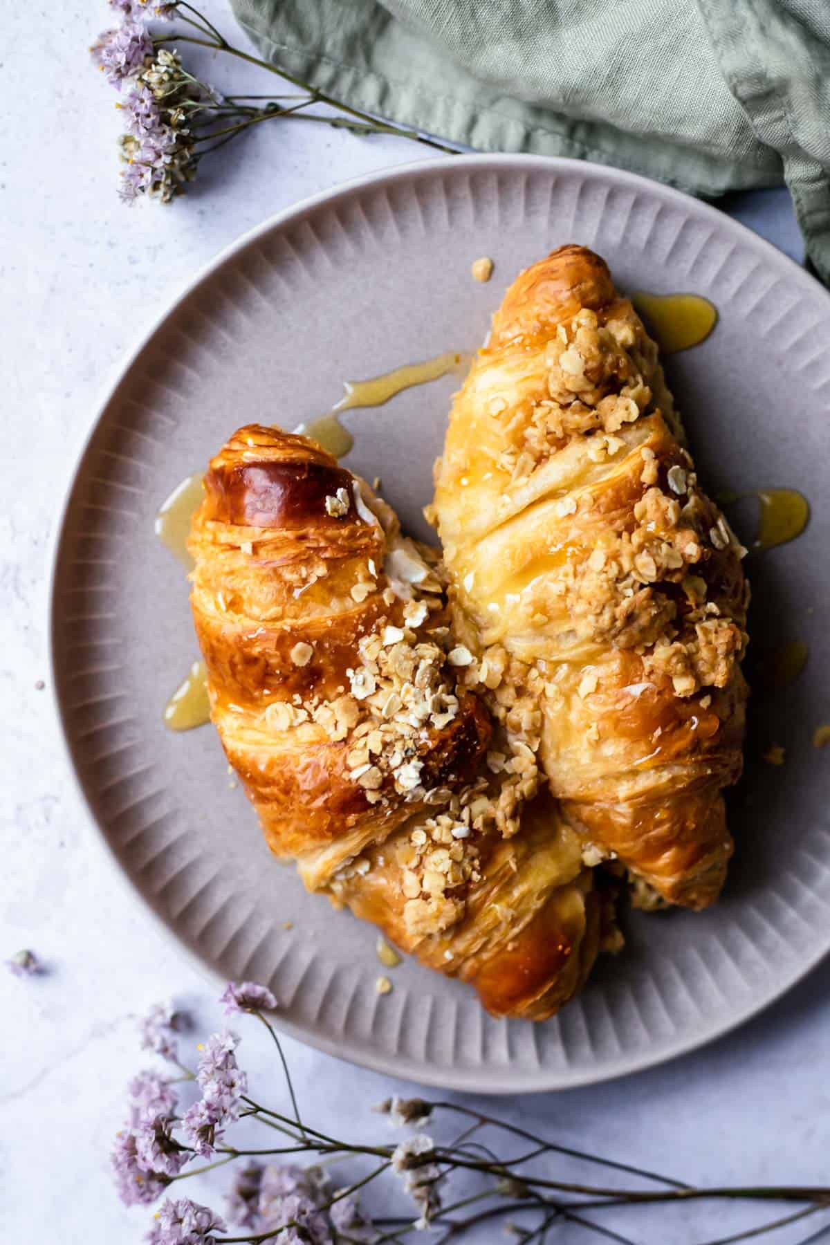 two cinnamon crisp apple french toast bake croissants on a plate