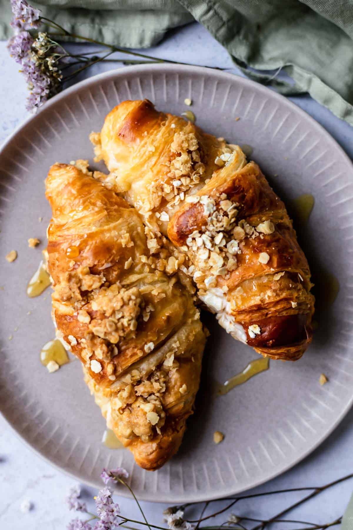 two cinnamon crisp apple french toast bake croissants on a plate