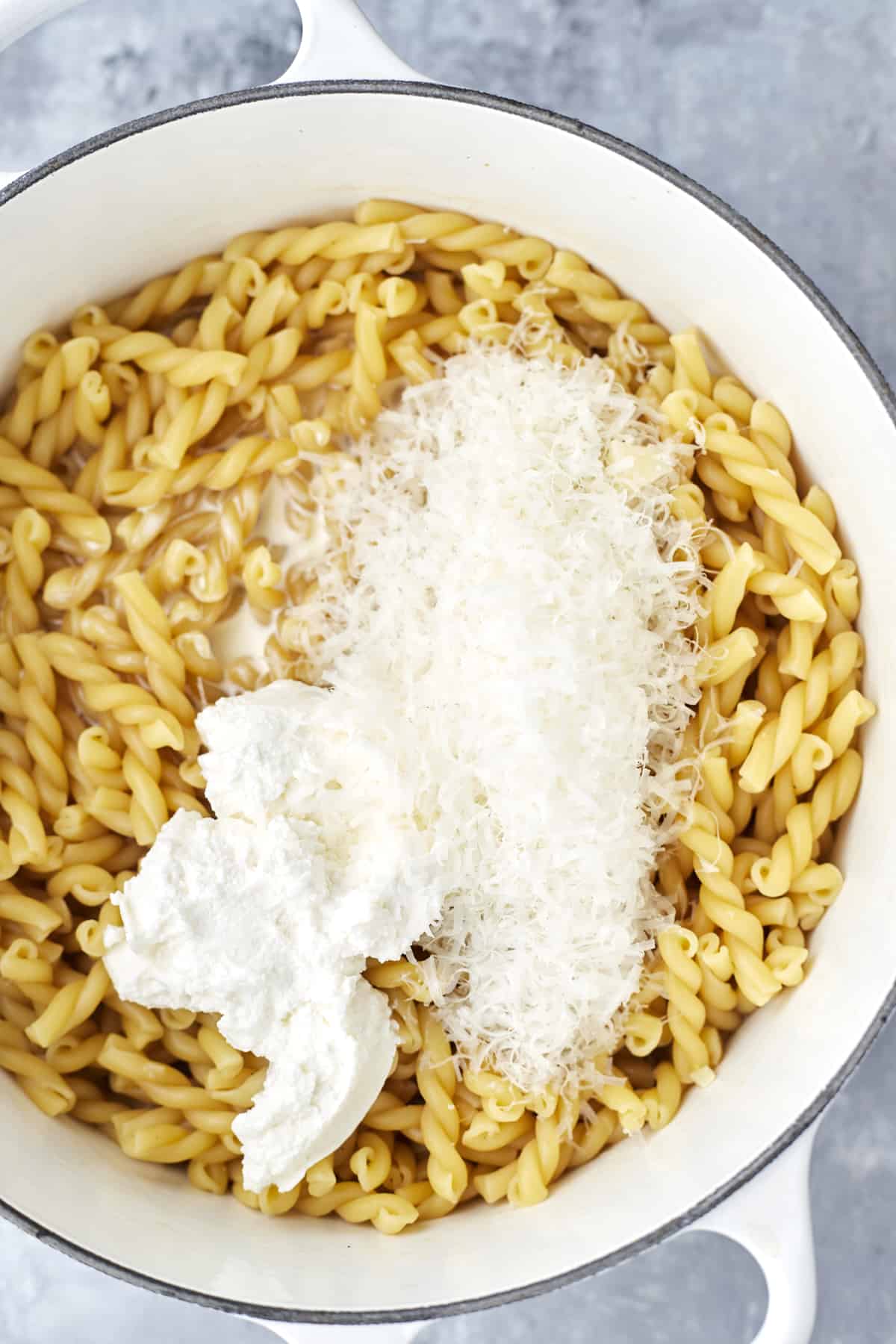 pasta noodles topped with Parmesan cheese and heavy chreese