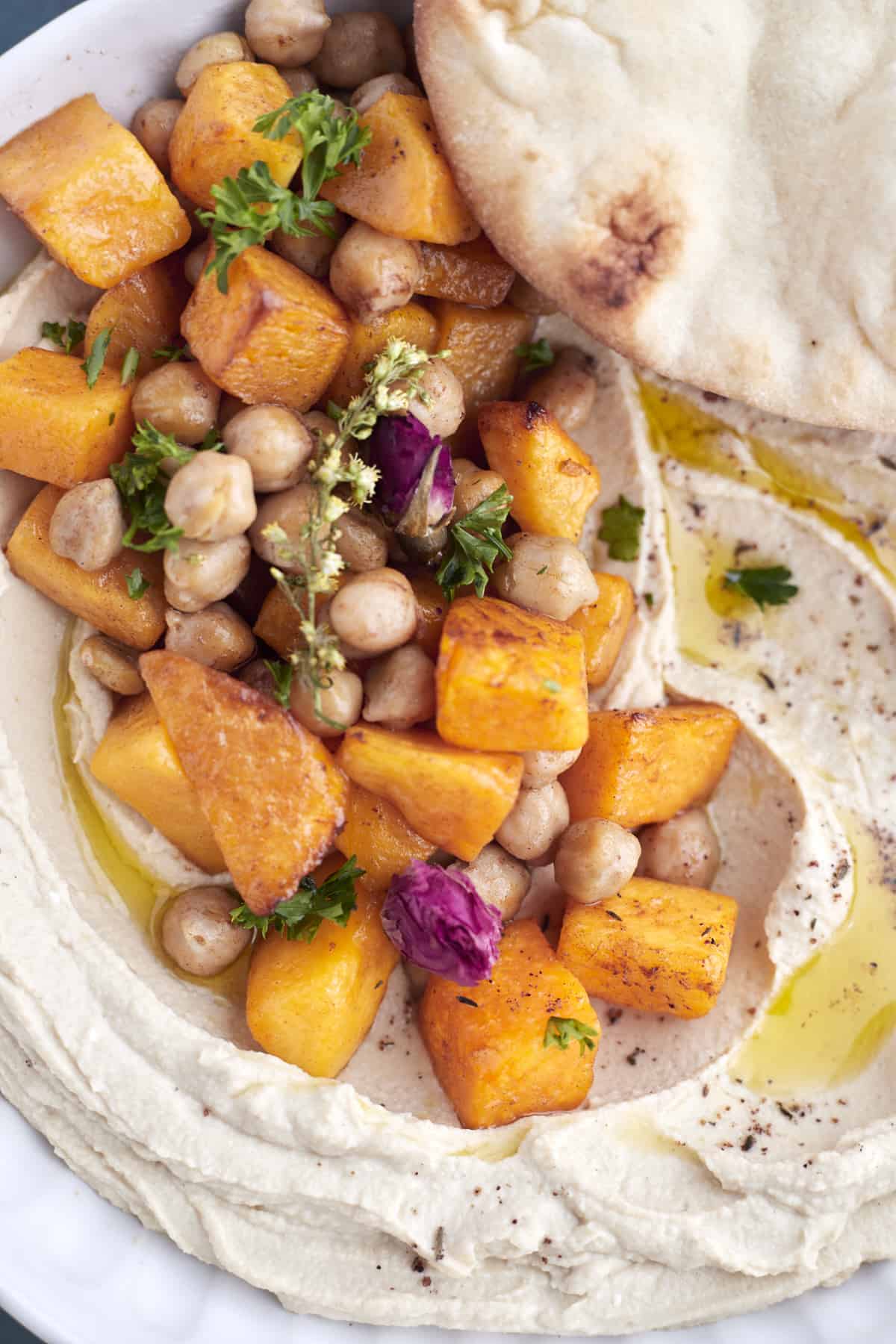close up image of cinnamon roasted chickpeas and butternut squash over roasted maple butternut squash hummus