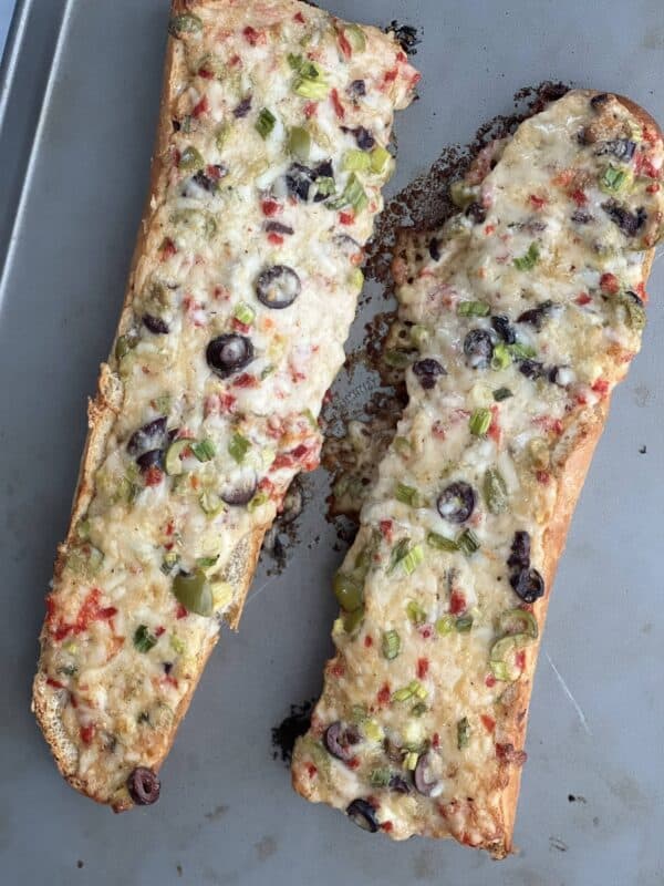 two pieces of olive cheese bread with peppers and olives