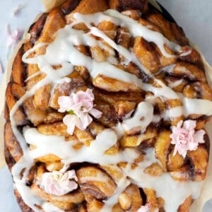 overhead image of slow cooker apple cinnamon rolls topped with a drizzle of icing