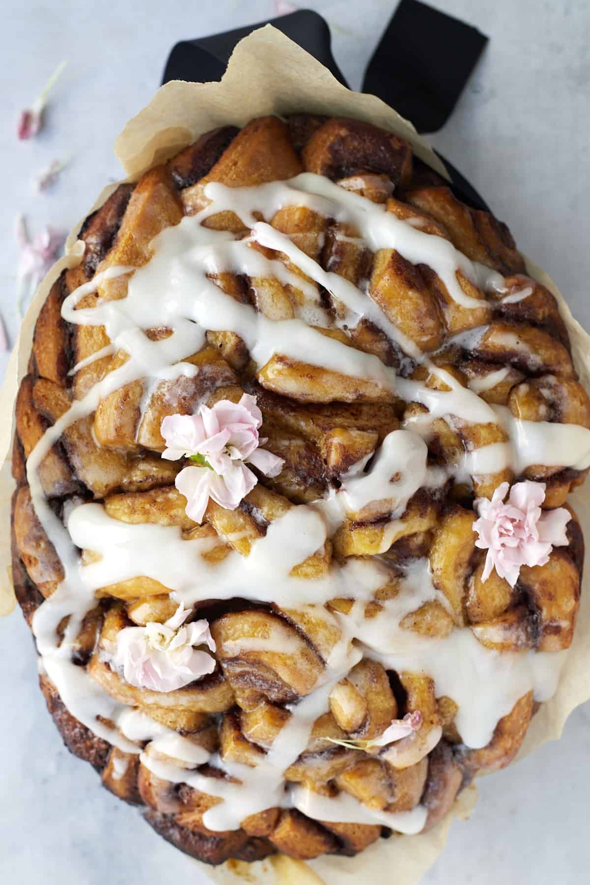 overhead image of slow cooker apple cinnamon rolls topped with white icing.
