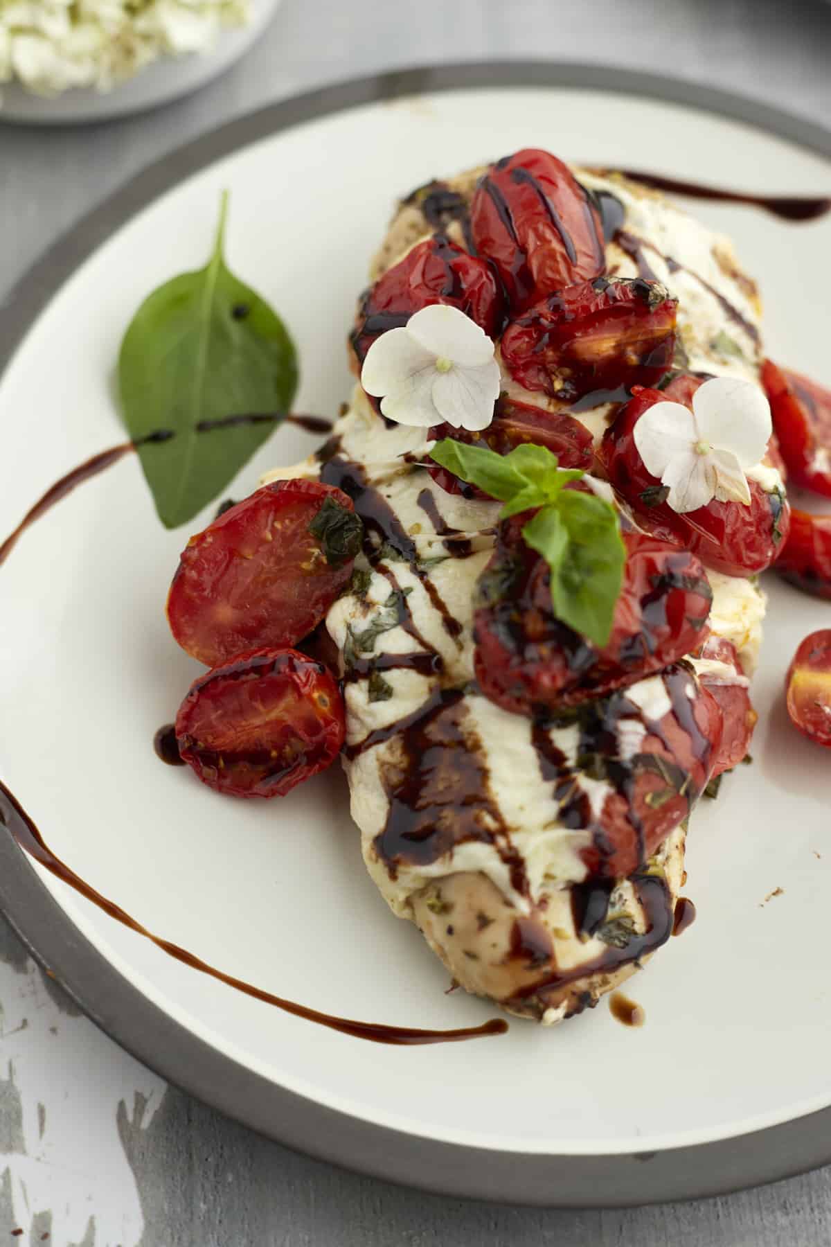 baked bruschetta chicken on a white plate