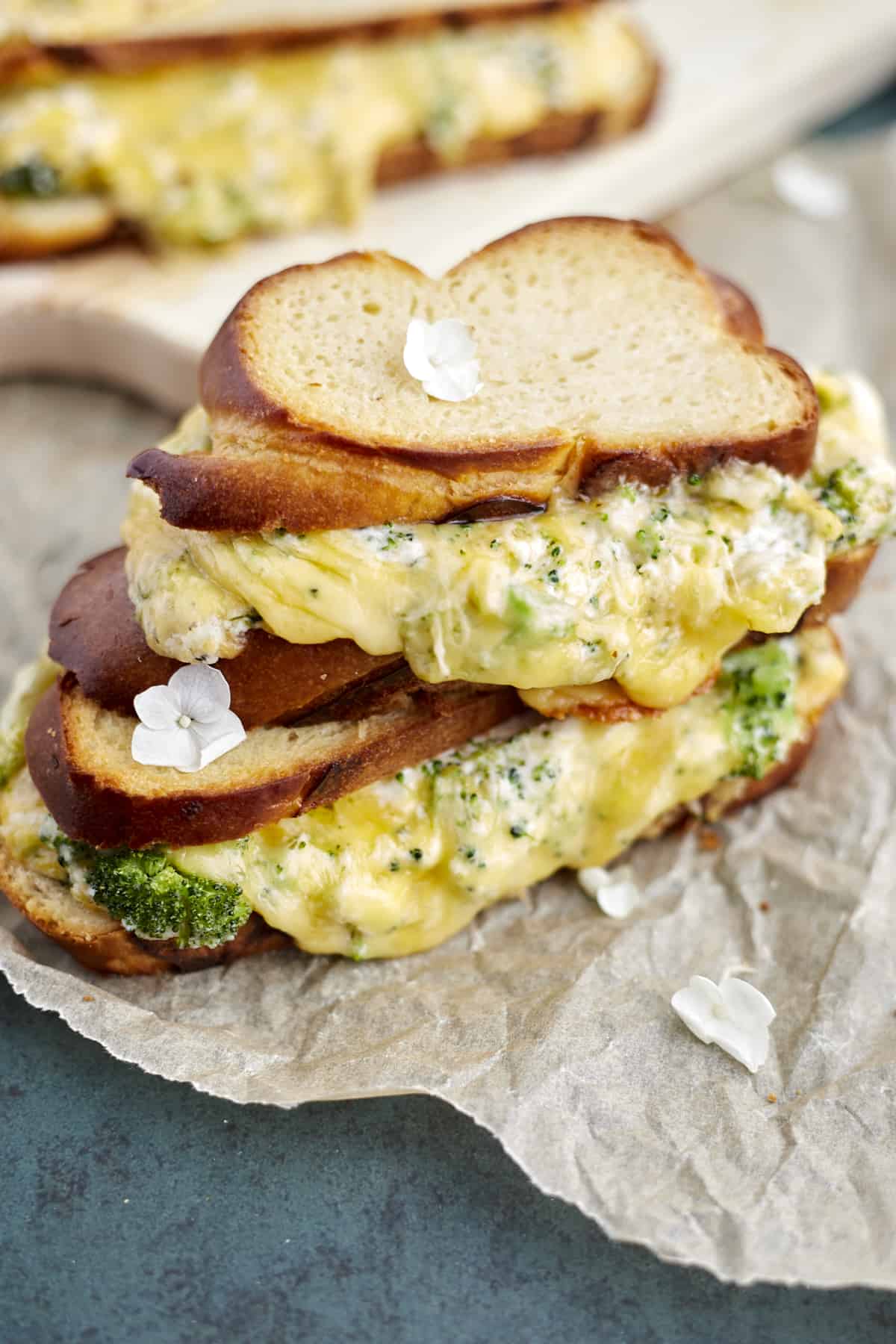 two roasted garlic and broccoli oven grilled cheese sandwiches. 