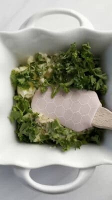 a spatula combining herb garlic butter