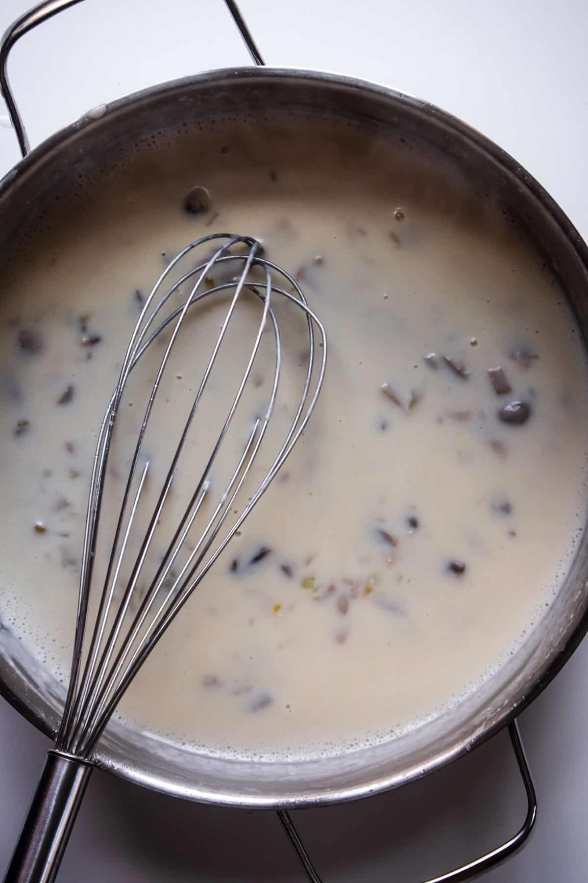 roux in a pot with a whisk on top
