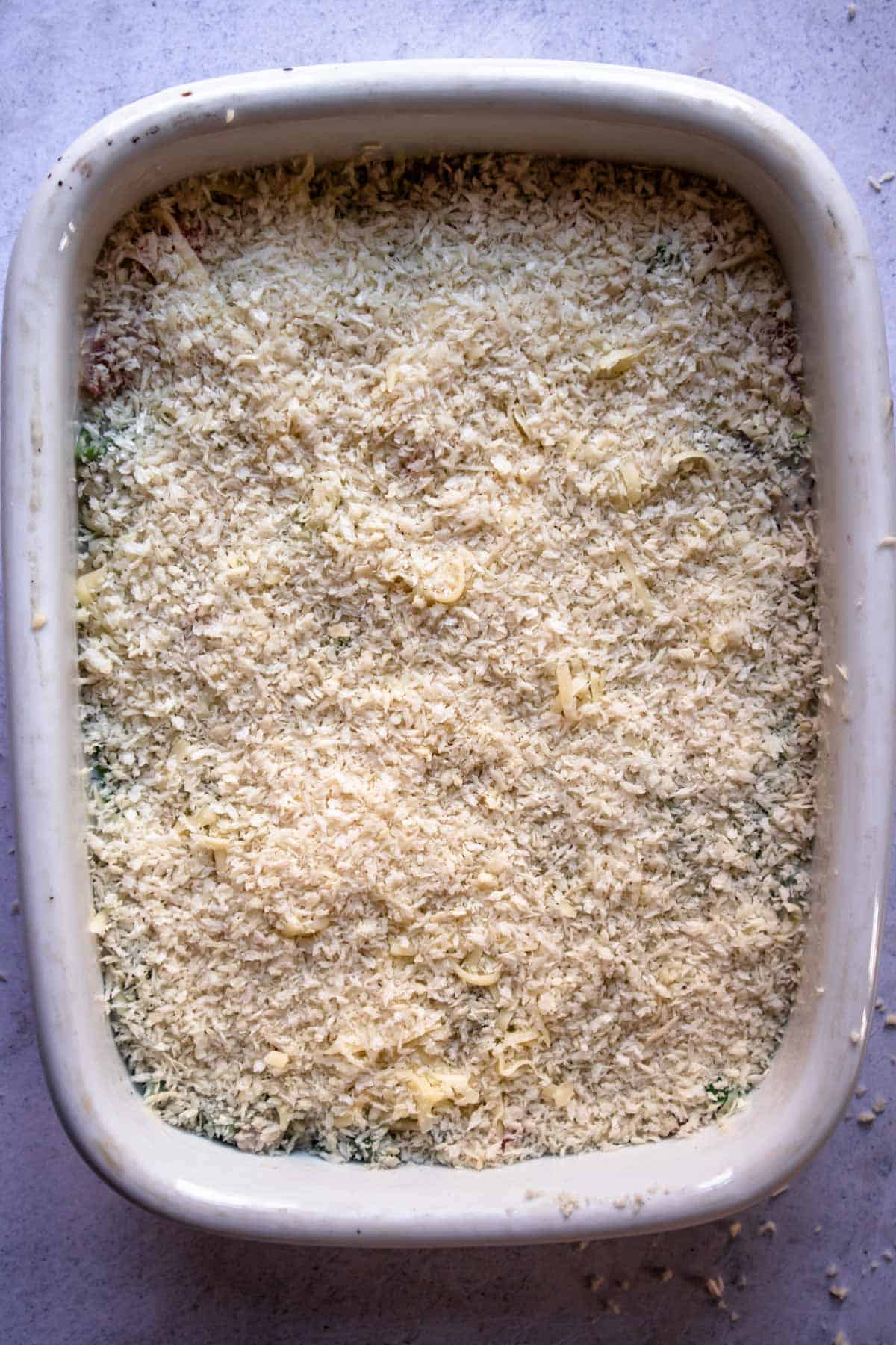 breadcrumbs over a casserole in a baking dish