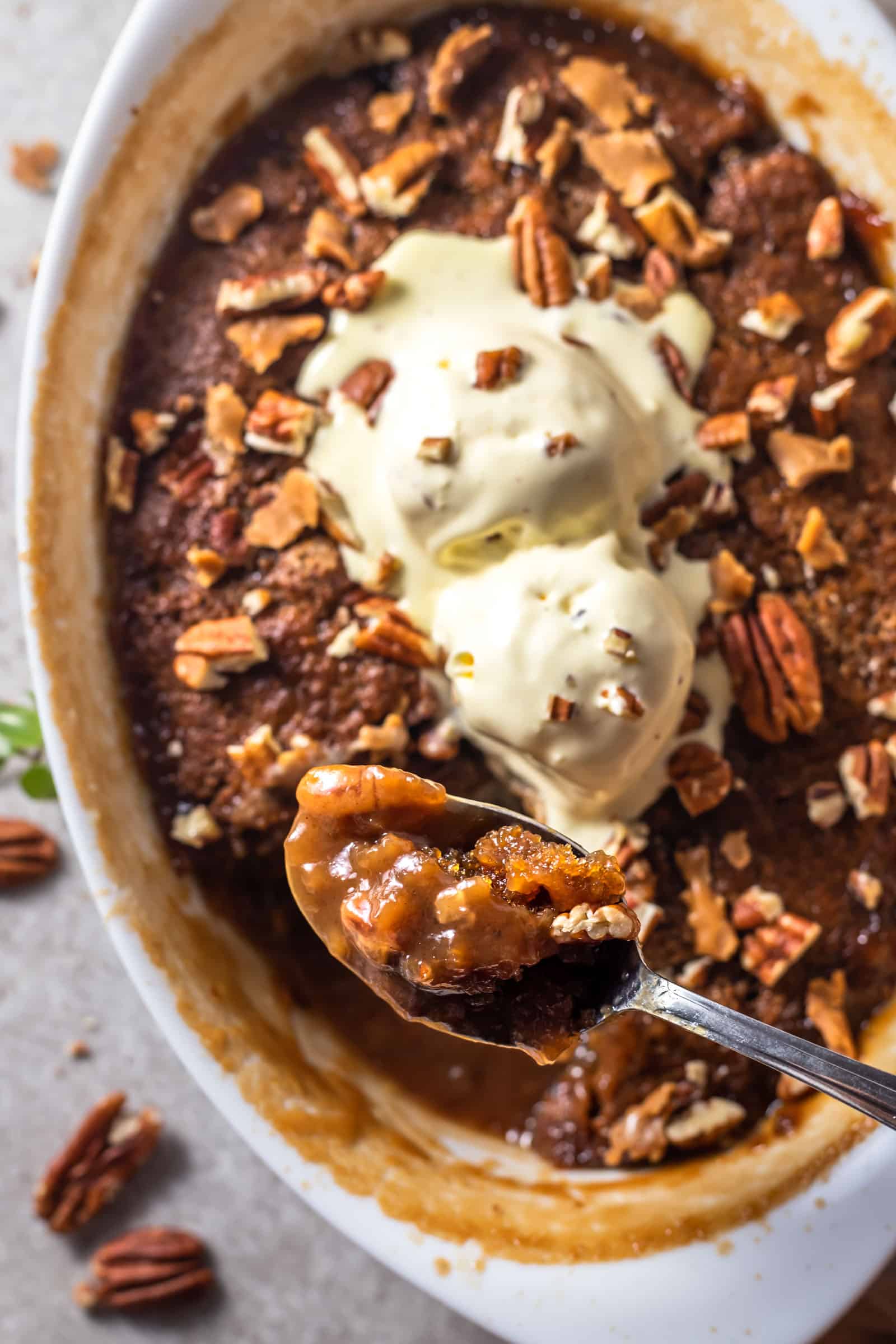a spoon scooping up a bite of easy pecan pie cobbler 