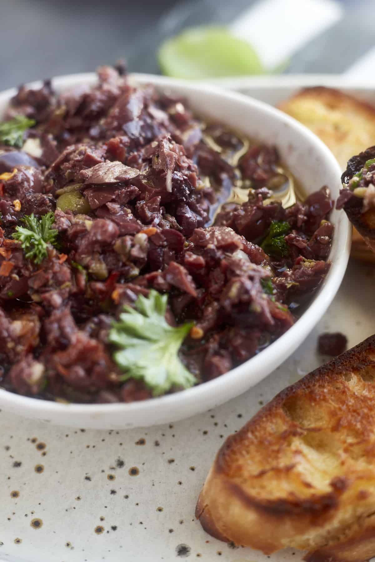 close up image of a bowl of easy olive tapenade