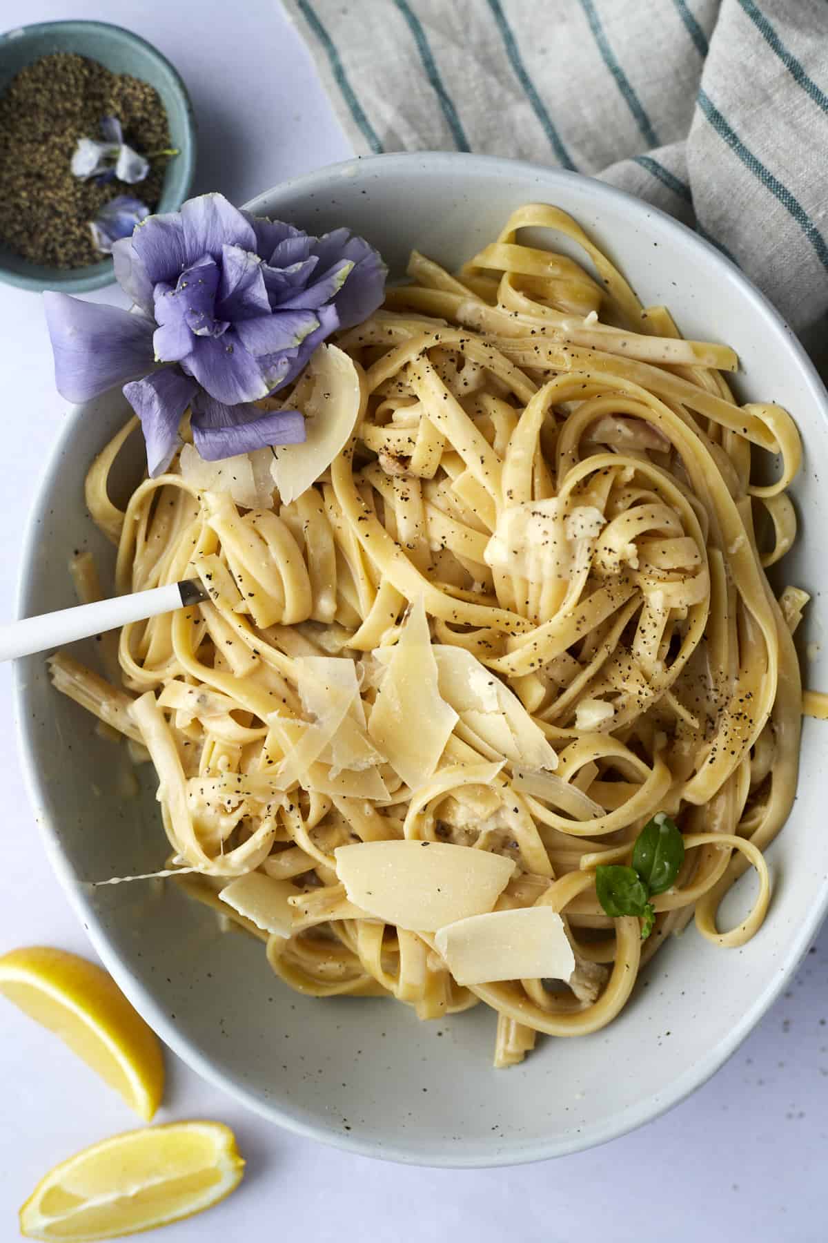 A bowl of one pot fettuccine alfredo with a fork twirled around a bite.