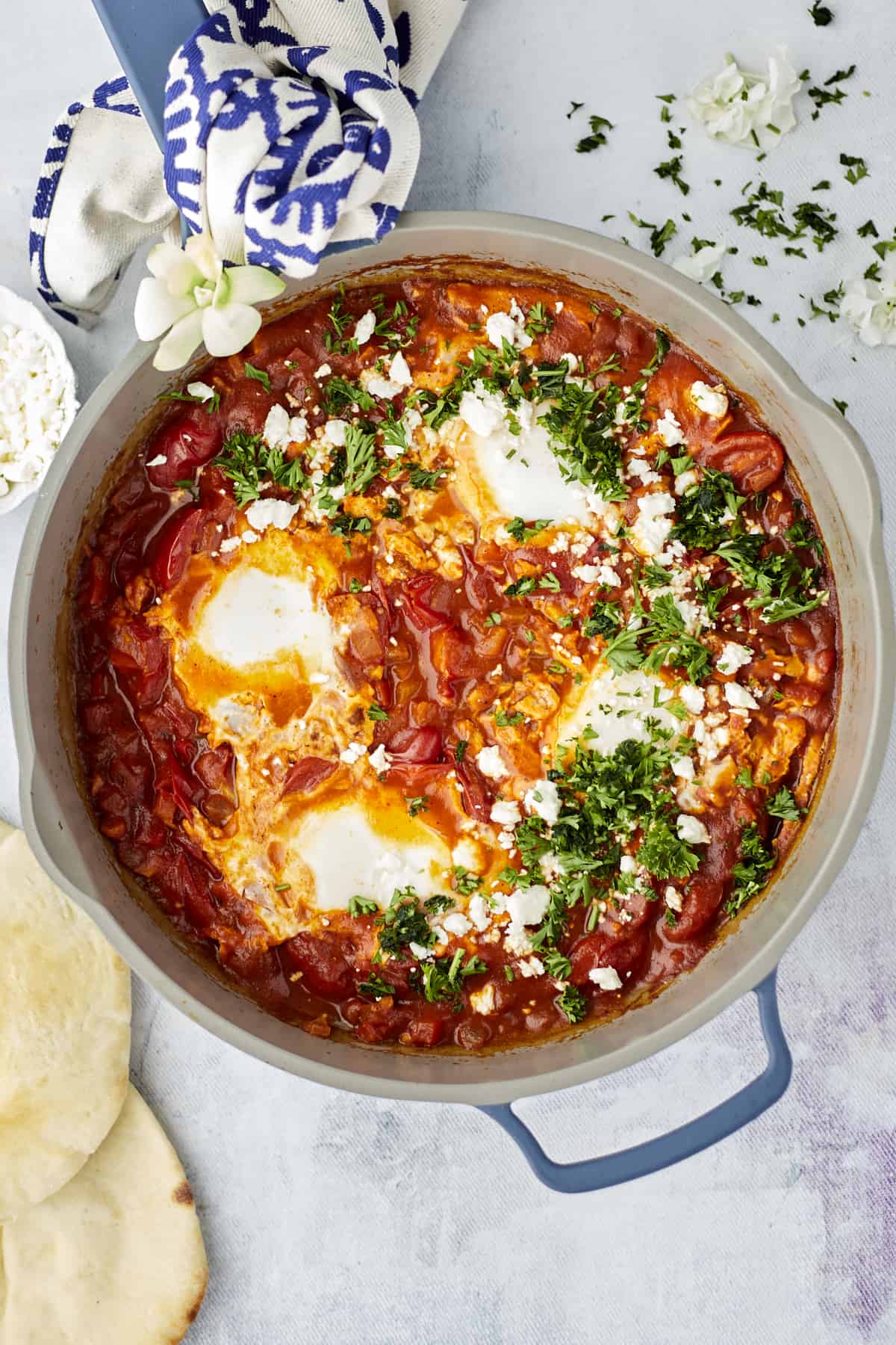 overhead image of easy shakshuka with feta topped with fresh herbs