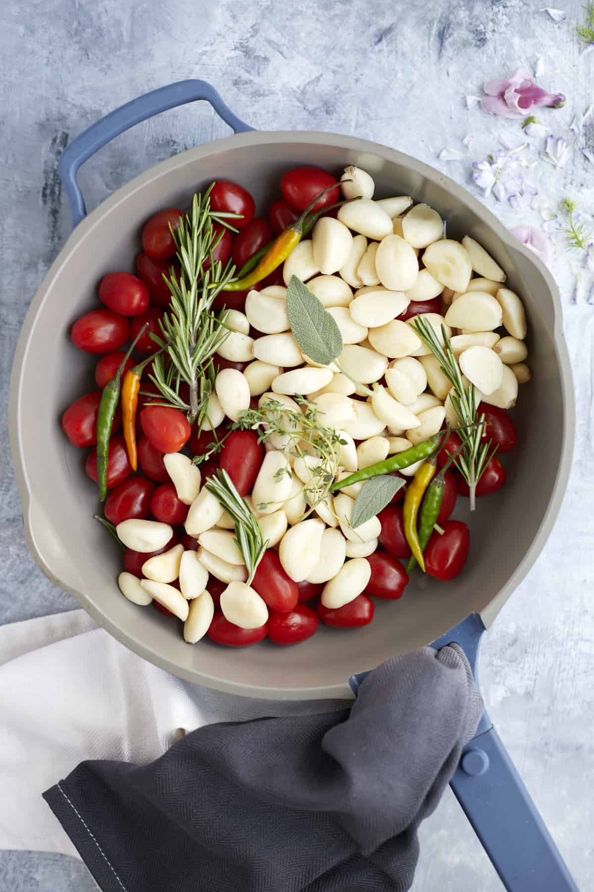 overhead pan with tomatoes, chili peppers, garlic, and herbs