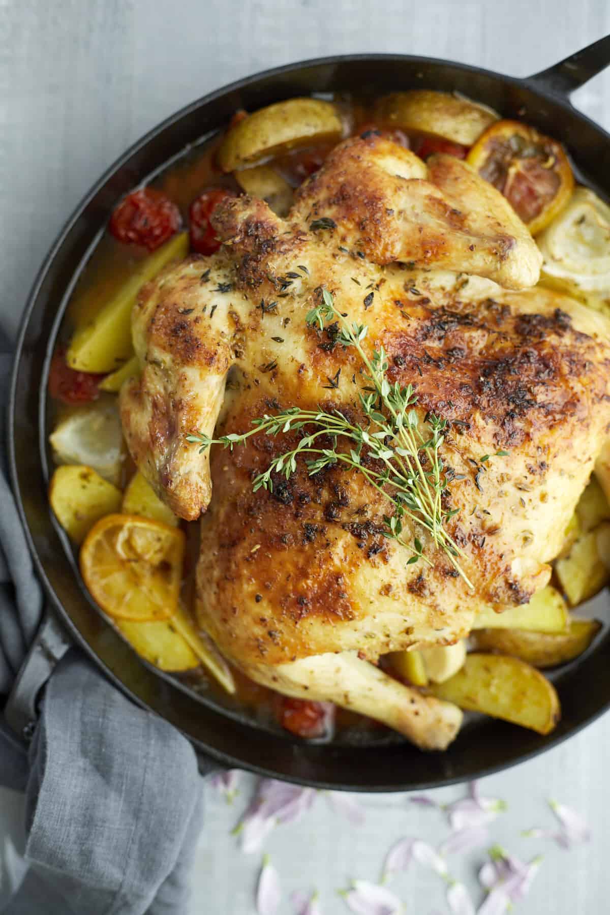 roasted chicken and vegetables in a cast iron pan