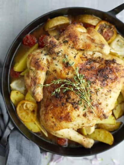 overhead of roasted chicken and vegetables in a pan