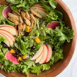 overhead image of a fall harvest salad in a wooden bowl