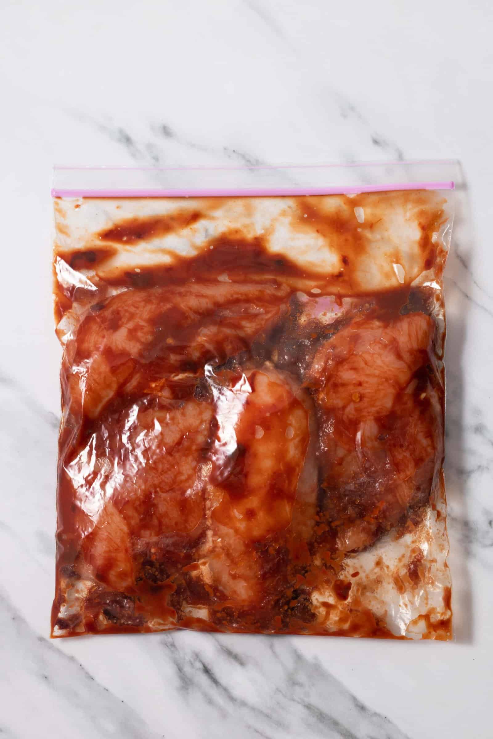 chicken marinading in chipotle sauce in a ziploc bag