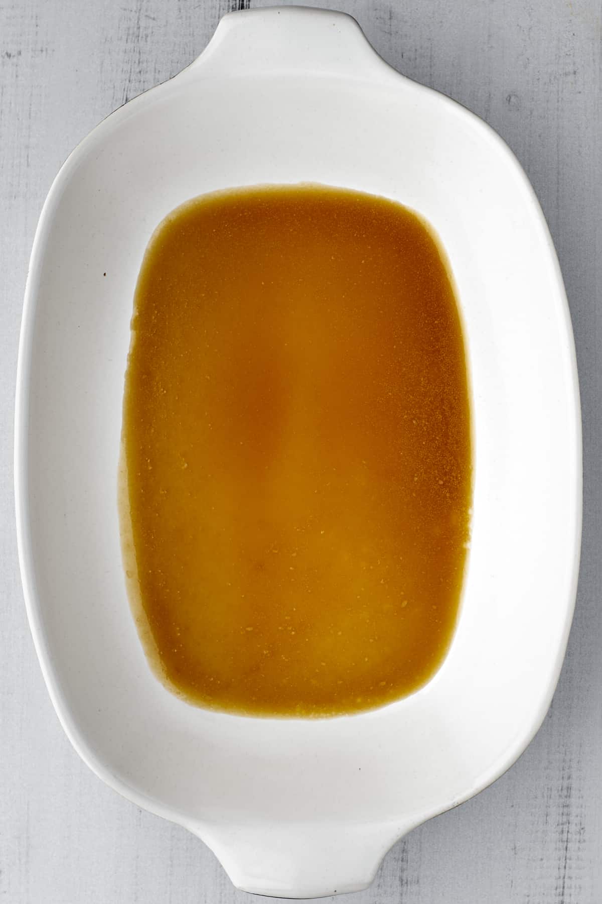 caramel sauce in the bottom of a baking dish