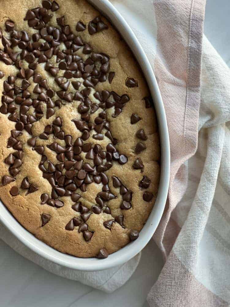 an oval dish with an inside out chocolate chip cookie